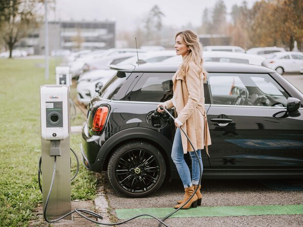 Mitarbeiterin lädt ihr Auto an einer Mitarbeiterladestation